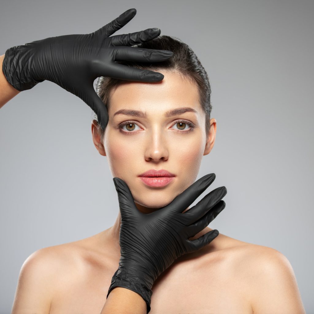 Best cosmetic surgery in St. Louis -Doctor checks a skin before plastic surgery - face