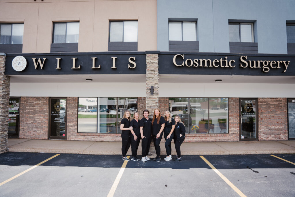 Team of cosmetic surgeons outside Willis Cosmetic Surgery in Ballwin, showcasing expertise in procedures like brachioplasty and body contouring.