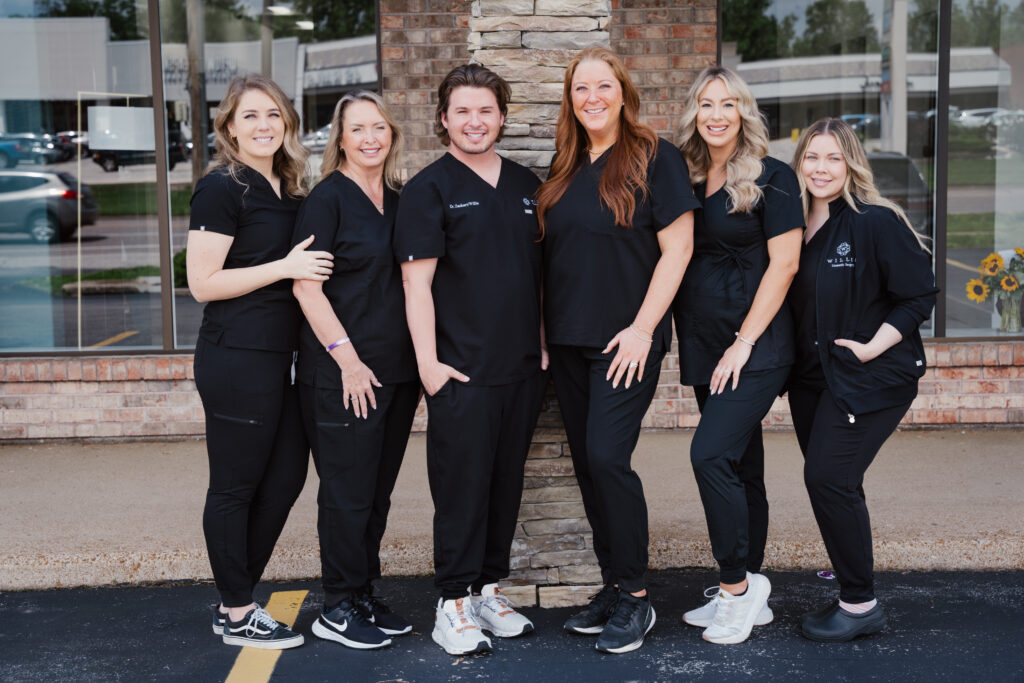 Team of cosmetic surgery professionals in black scrubs at Willis Cosmetic Surgery in Ballwin, showcasing expertise in procedures like breast lift and awake cosmetic surgery.
